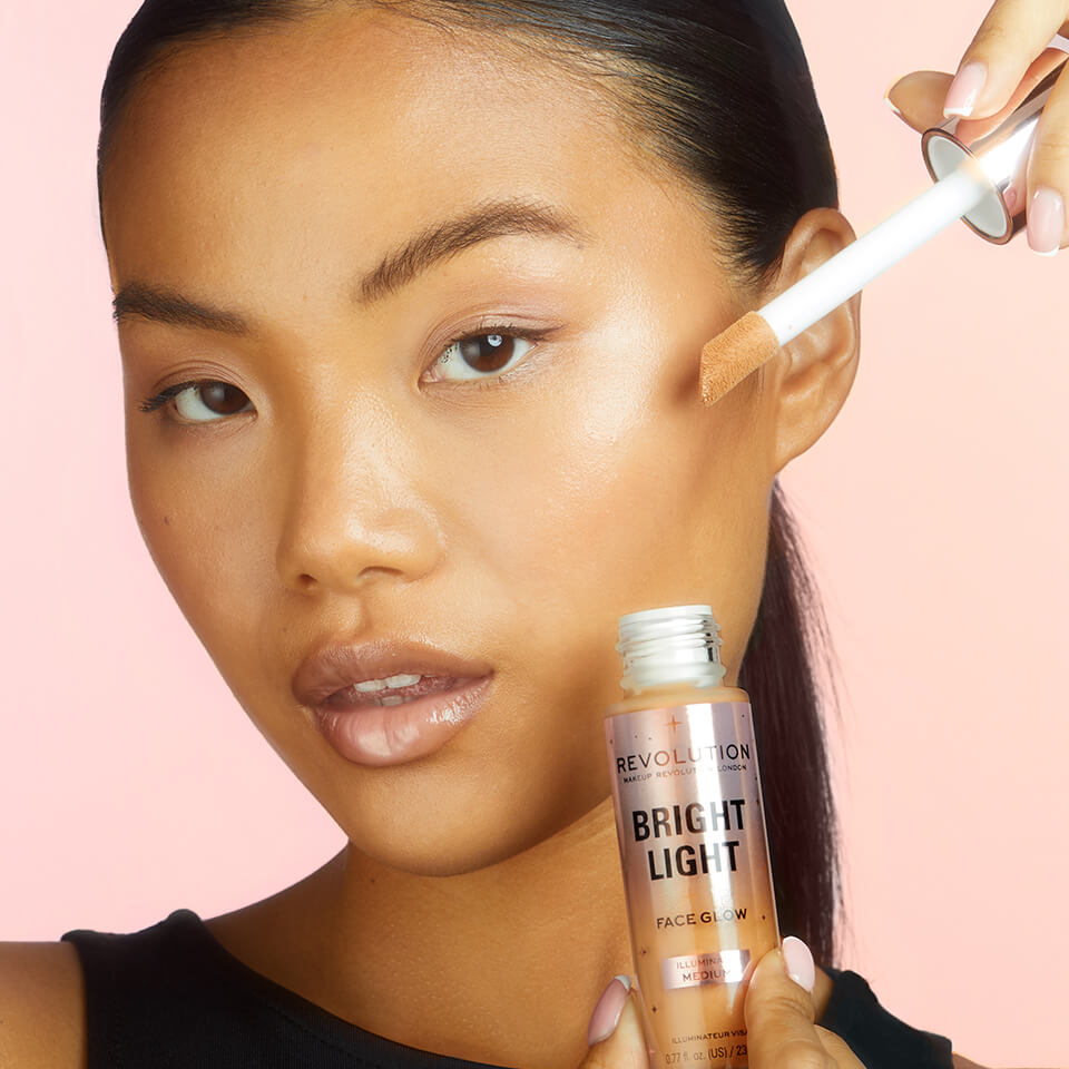 An image of a model holding the Makeup Revolution Bright Light Face Glow